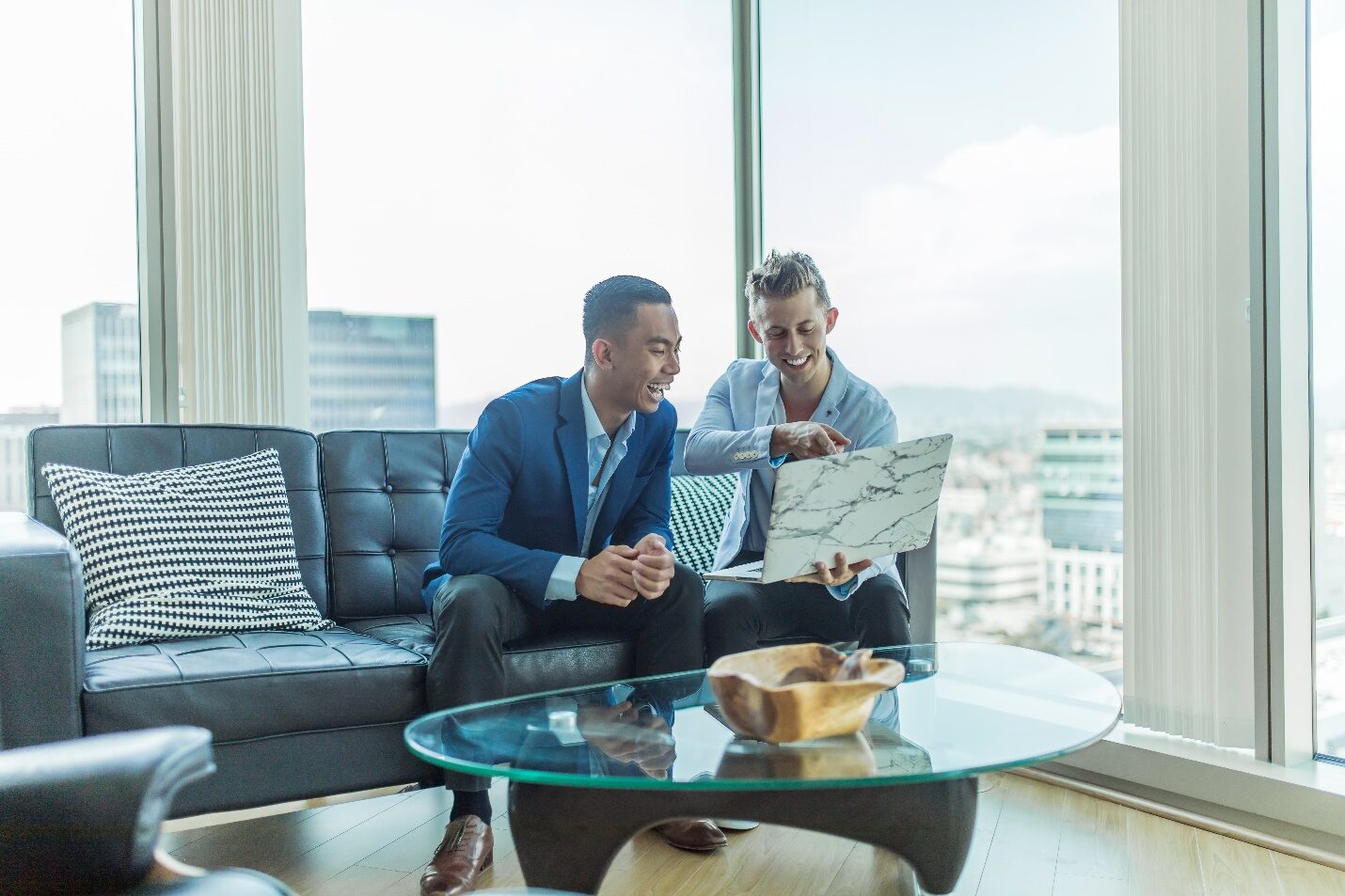 Two Real Estate Agents Using a Laptop