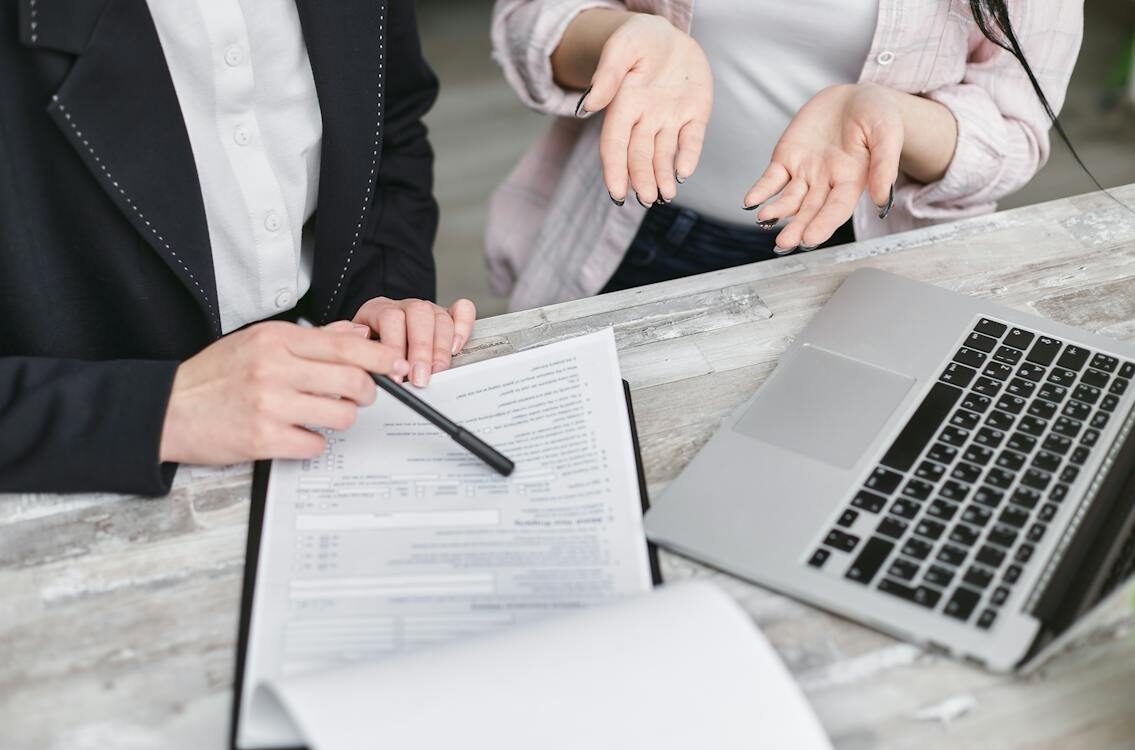 A Person Holding a Black Pen to Sign