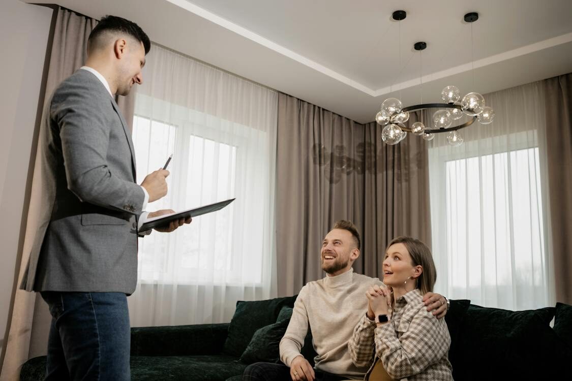 Realtor in Gray Suit Jacket Talking to Clients