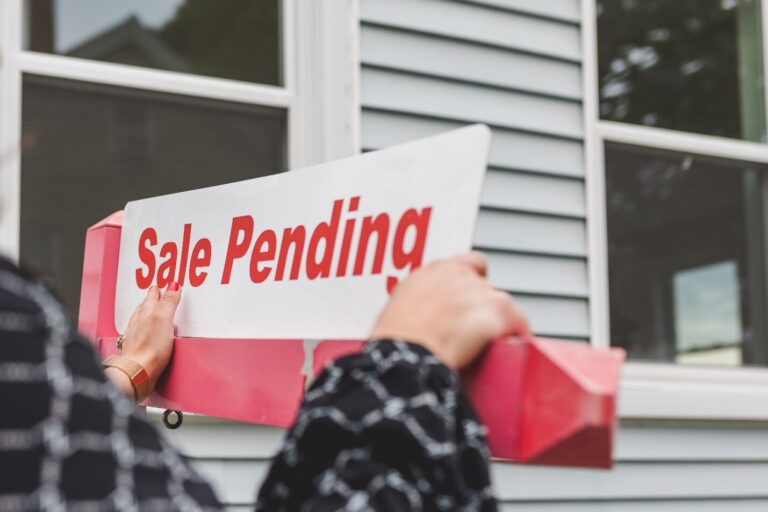 Realtor Pasting a ‘Sale Pending’ Sign