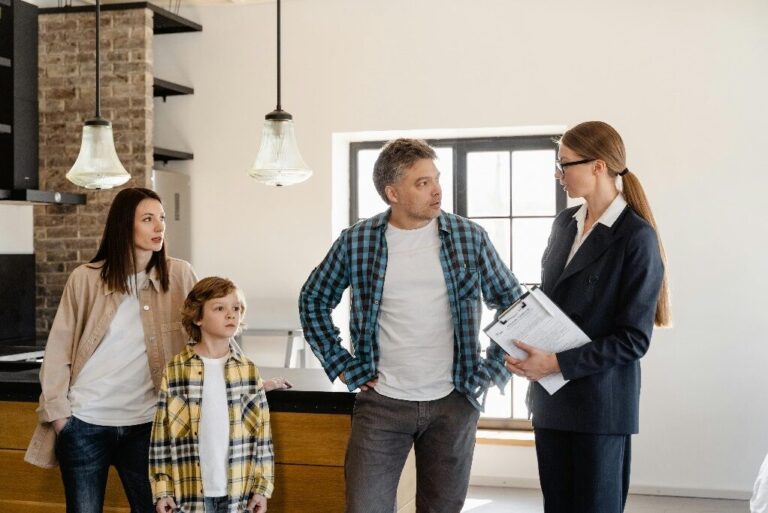 A real estate agent speaking to a family