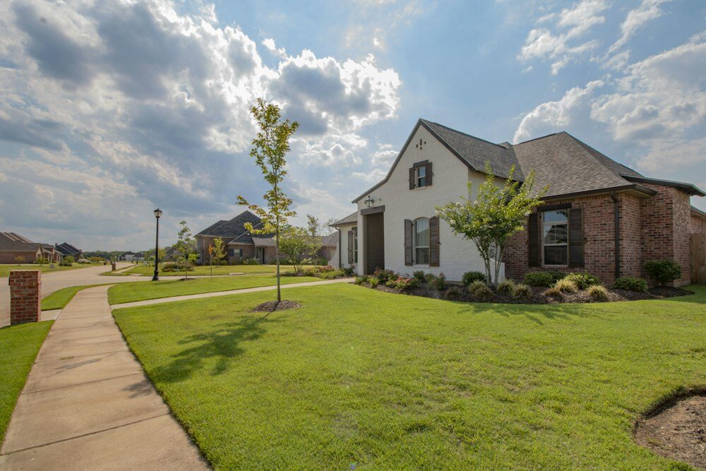 House near a green grass field 