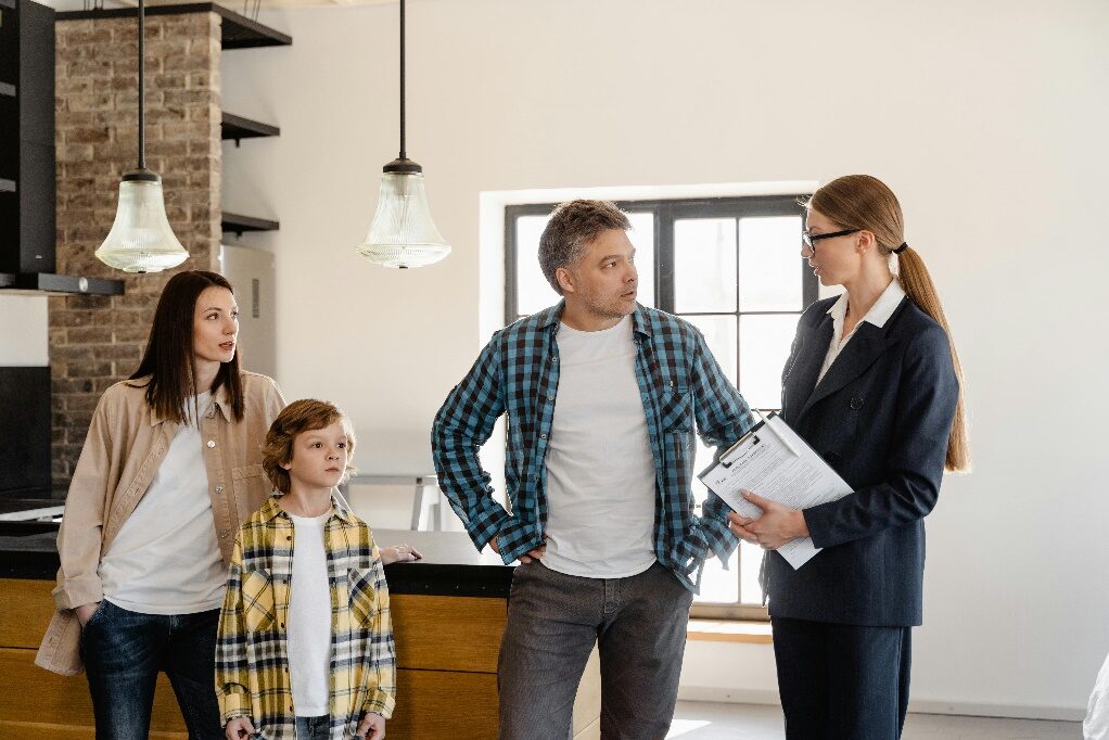 A real estate agent speaking to a family