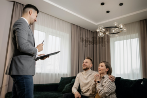 Realtor With Clients by https://www.pexels.com/photo/person-in-gray-suit-jacket-talking-to-clients-7641893/