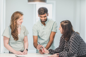 Realtor Talking to Clients About Investment Strategies by https://www.pexels.com/photo/real-estate-agent-in-black-printed-blouse-having-negotiation-to-a-couple-home-buyers-8293702/