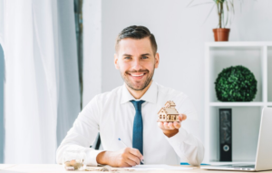 Real Estate Agent Holding a Miniature House