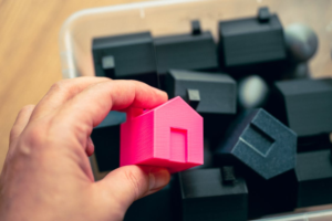 Person holding home model for real estate decisions