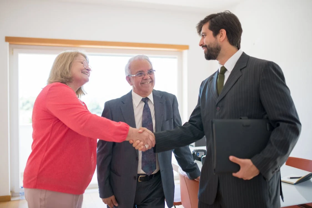 A real estate agent shaking hands with a client