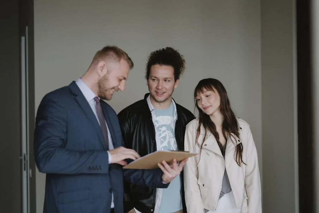 A real estate agent reviewing documents with a client in a home setting