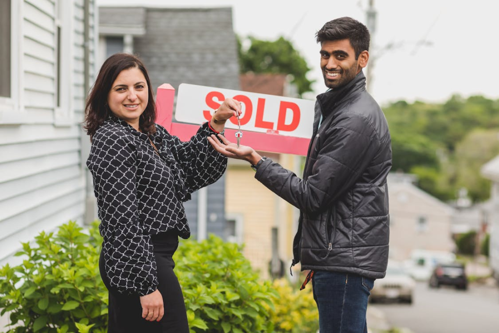 Real estate agent handing the house key to the buyer