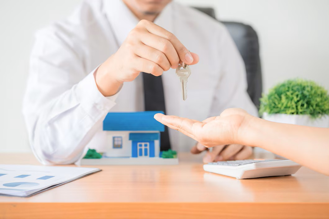 Real estate agent giving clients the house keys