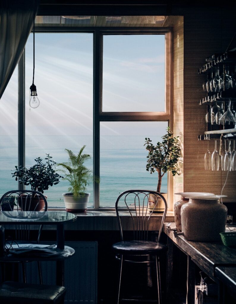 A kitchen window with a view of the ocean