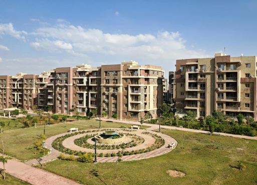 This image shows an apartment complex surrounding a landscaped community park.