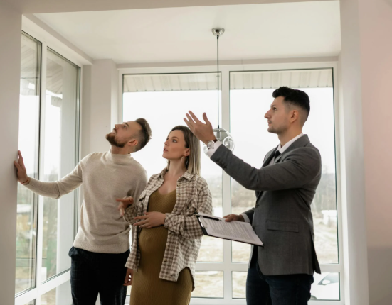 This image shows an agent guiding prospective buyers through a property.