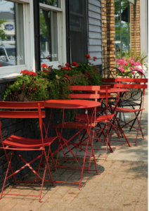 This photo shows a row of tables and chairs.