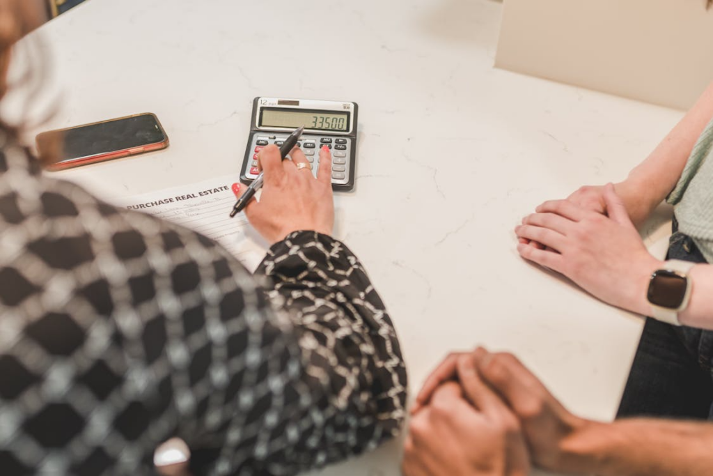 a realtor calculating the cost of a real estate property with their clients