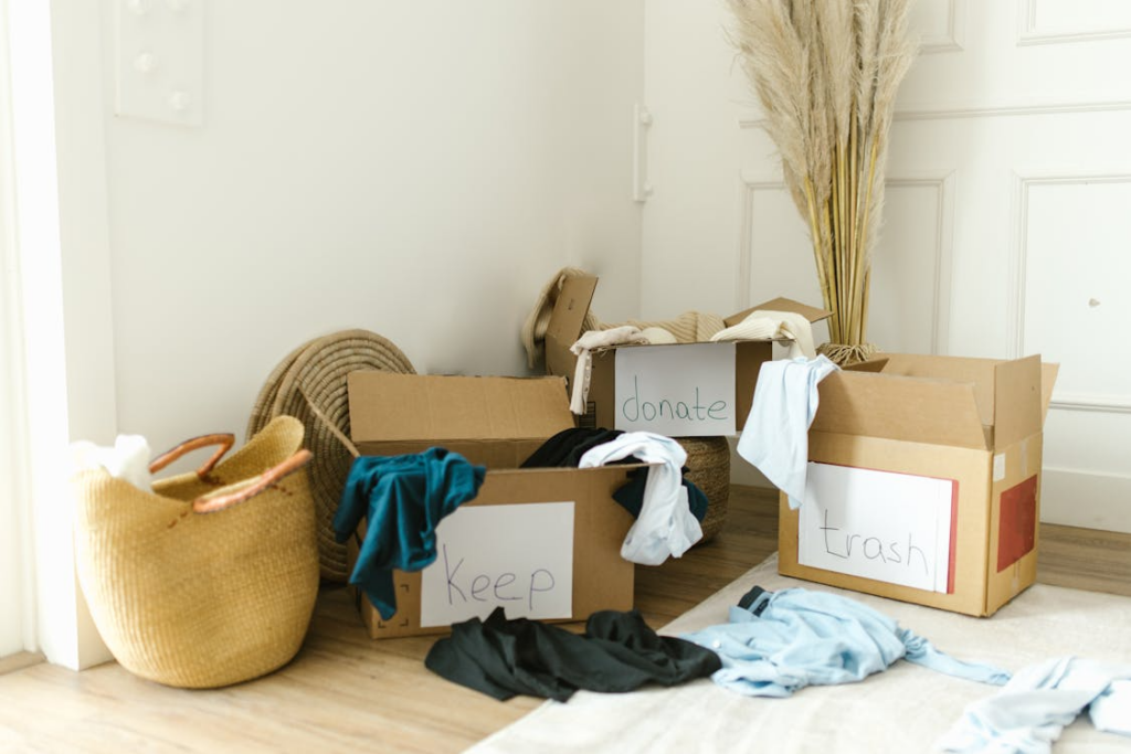 Boxes labeled keep, donate, and trash during the home decluttering process