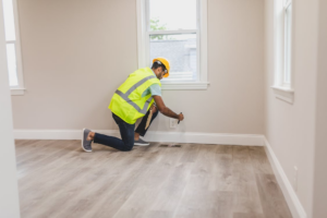 Home inspector checking the electrical outlet inside a house during inspection