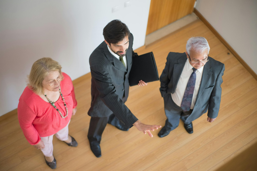 Real estate agent showing clients a house